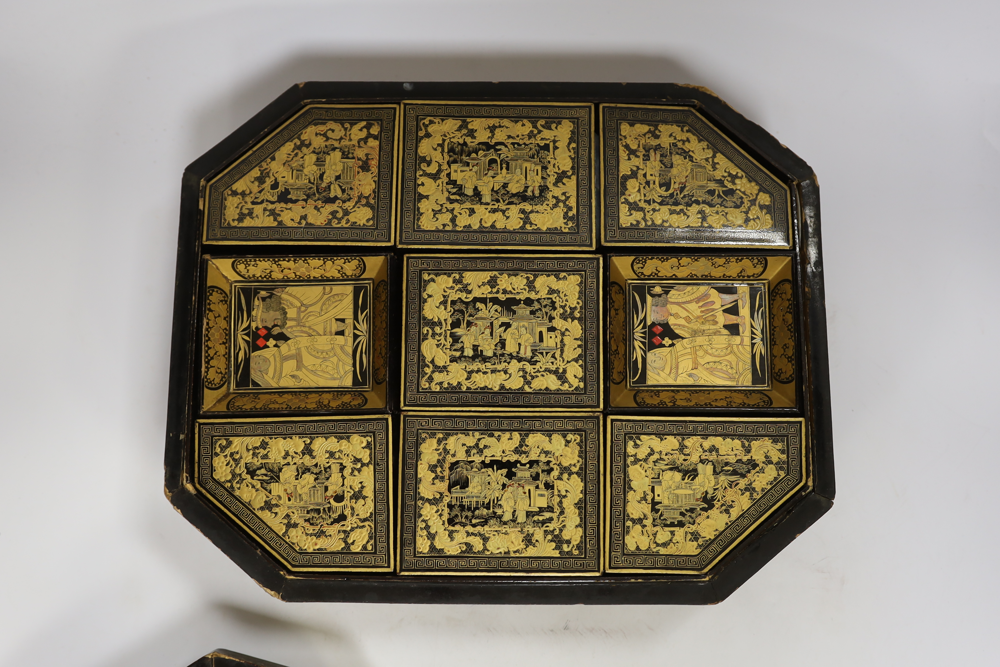 A mid 19th century Chinese gilt-decorated black lacquer games box containing mother-of-pearl counters